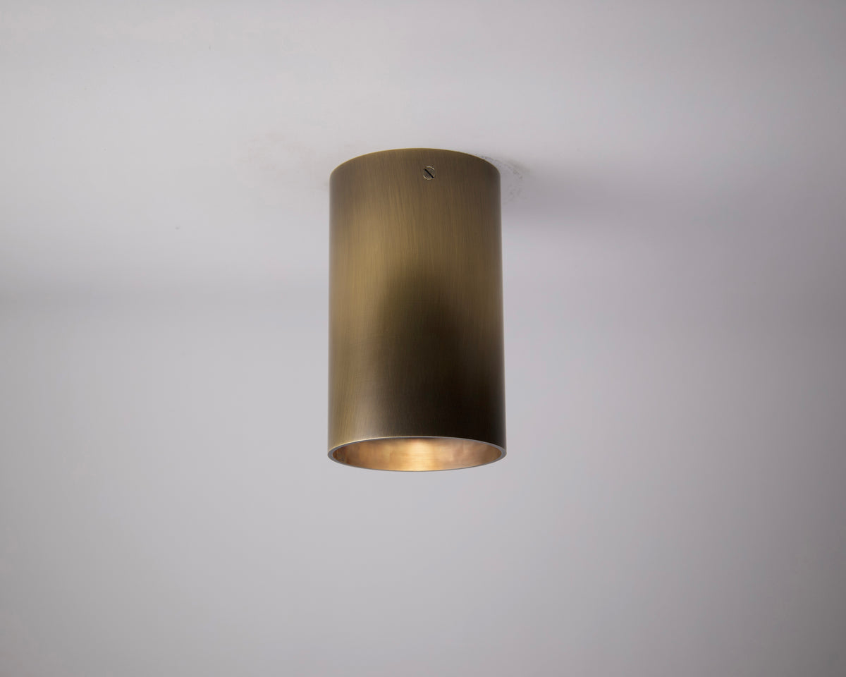 The Long Made Co. Beau Laiton - XL Trimless Spot (Ketra S30 Compatible) features a cylindrical form with a brushed metallic finish, seamlessly mounted on a white ceiling for minimalist luxury and soft downward illumination.