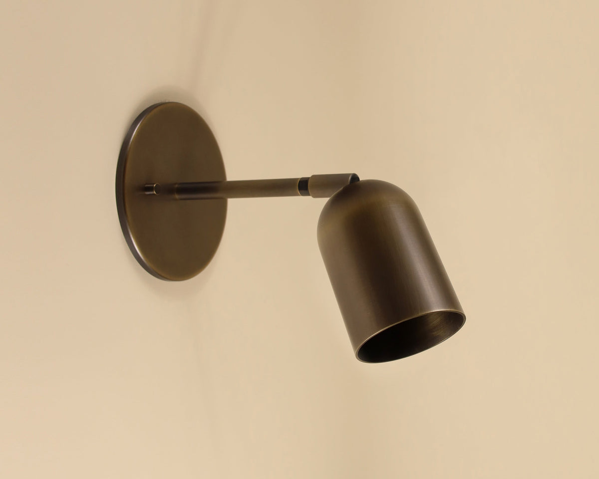 Bronze wall-mounted lamp on a beige background