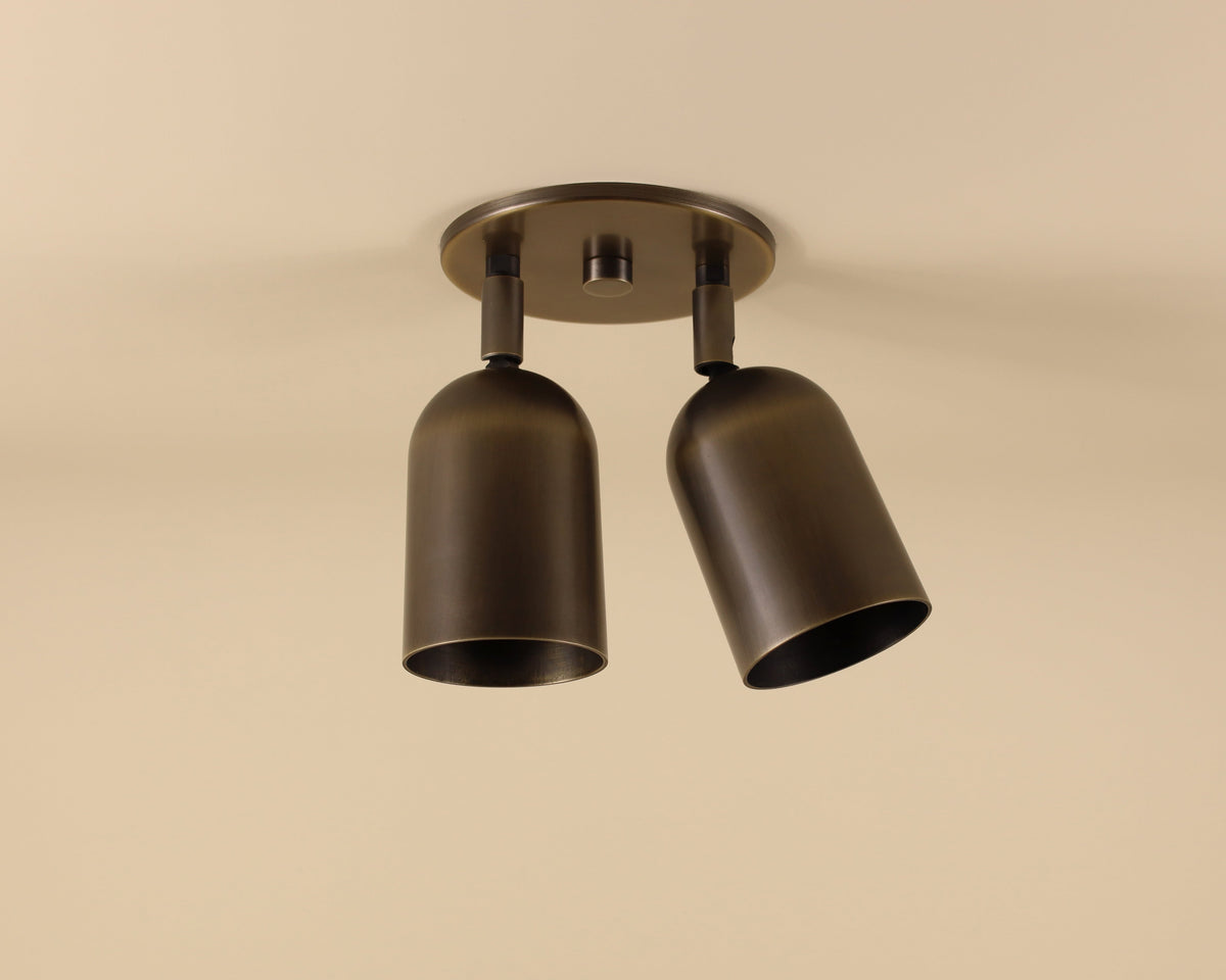Two cylindrical ceiling lights on a beige background