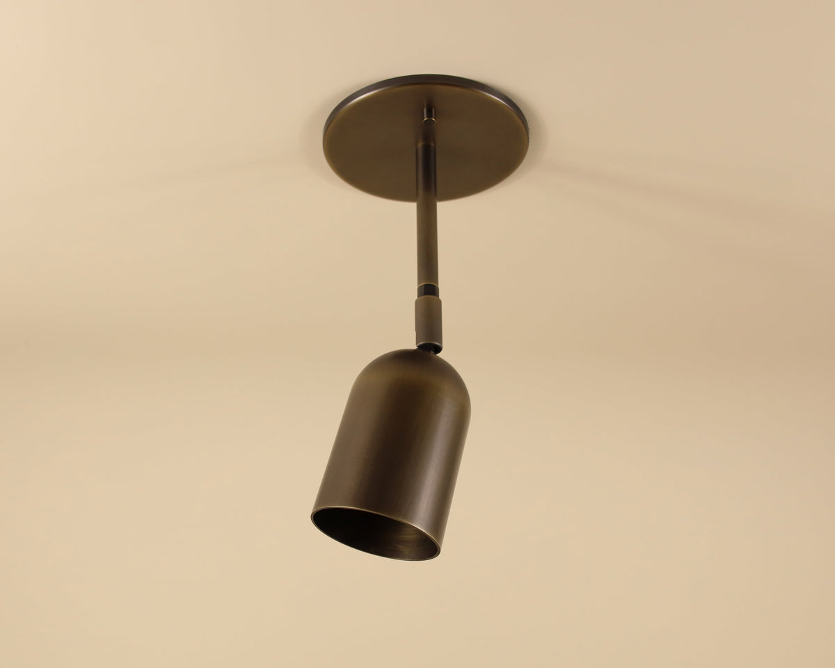Bronze pendant light fixture on a beige background