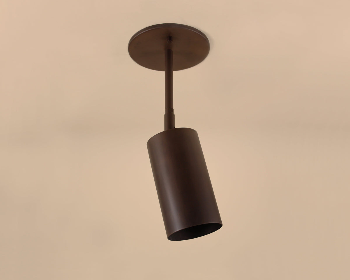 Dark bronze pendant light fixture on a beige background