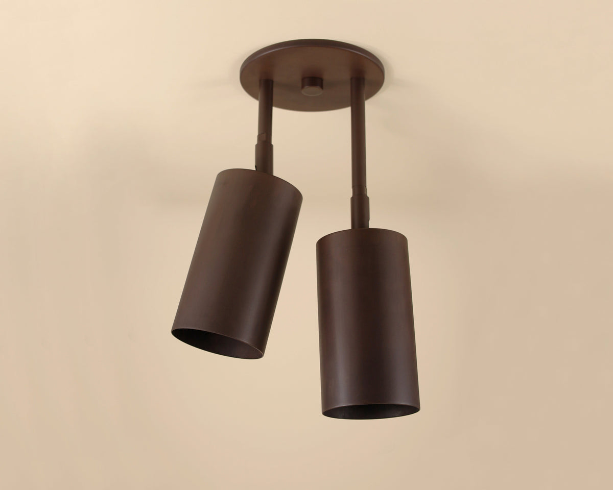 Double cylindrical ceiling light fixture on a beige background