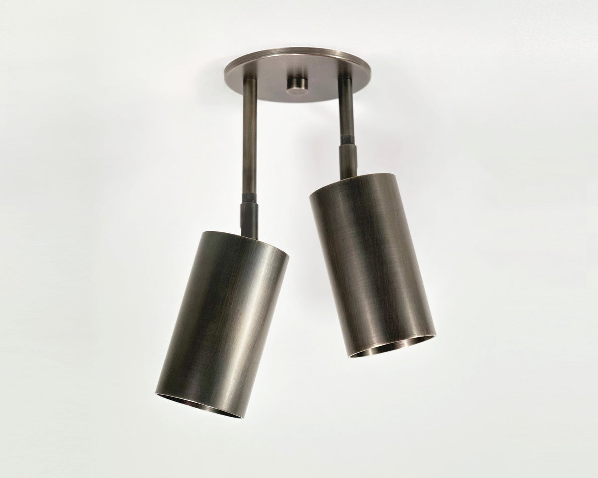 The Highland Double Drop Spot by Long Made Co. features two adjustable cylinder lights, ideal for directing illumination exactly where you need it.