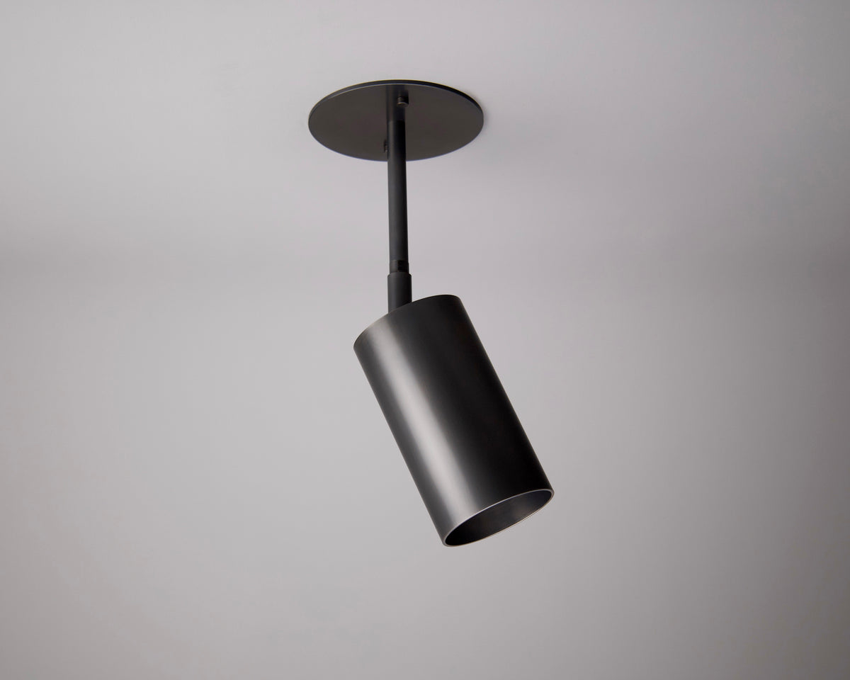 The Highland Drop Spot by Long Made Co. is a modern black ceiling mono point spotlight, mounted on a plain white ceiling and angled downward for focused task lighting.