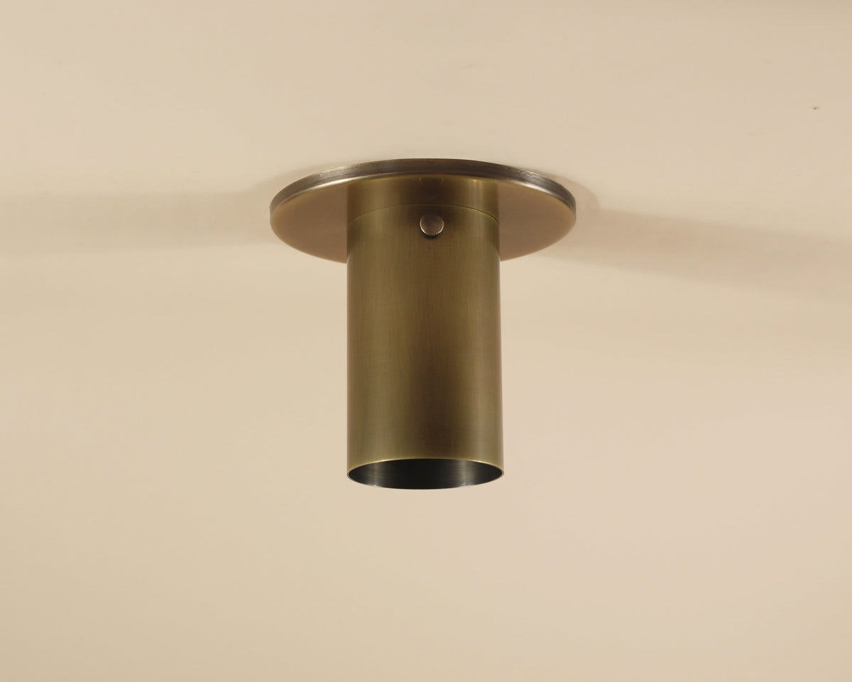 Bronze ceiling light fixture on a beige background