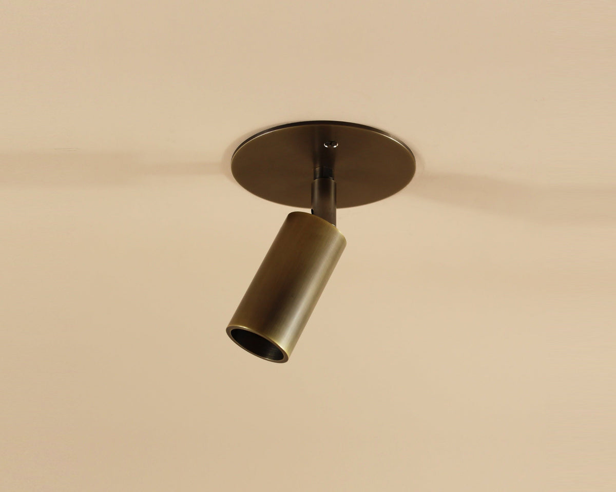 Bronze ceiling light fixture on a beige wall