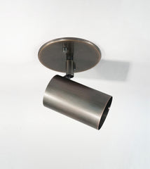 The Brass Cylinder Adjustable Spot - Side Mount by Long Made Co. features a cylindrical adjustable head on a round base, inspired by mid-century modern lighting and shown against a plain white background.